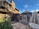 Landscaped backyard with stone patio, gazebo, and spiral staircase at 7345 E Hinsdale Pl, Centennial, CO 80112