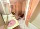 Retro bathroom featuring a pink sink, toilet, and bathtub with tile surround at 7345 E Hinsdale Pl, Centennial, CO 80112