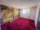 This bedroom has a red carpet, pink walls, and a wallpapered mural of a grove of trees at 7345 E Hinsdale Pl, Centennial, CO 80112