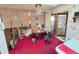 Dining area with mirrored wall, ceiling fan, patterned wallpaper, and red carpeting at 7345 E Hinsdale Pl, Centennial, CO 80112