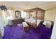 Main bedroom with dark wood furniture, purple carpet, and floral wallpaper at 7345 E Hinsdale Pl, Centennial, CO 80112