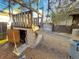 Wooden playhouse with a swing, slide, and enclosed area for imaginative play at 7345 E Hinsdale Pl, Centennial, CO 80112