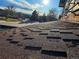 Close-up of a brown shingle roof with a view of the neighborhood in the background at 7345 E Hinsdale Pl, Centennial, CO 80112