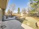 Spacious backyard with a shed, patio area, and mature trees offering ample shade at 7388 S Lafayette W Cir, Centennial, CO 80122