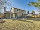 Exterior view of a home with a backyard featuring a patio and mature trees at 7388 S Lafayette W Cir, Centennial, CO 80122