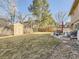 Large backyard featuring a shed, patio with furniture and well maintained landscaping at 7388 S Lafayette W Cir, Centennial, CO 80122