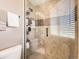 Bathroom featuring tiled shower, shower bench, and glass door at 7388 S Lafayette W Cir, Centennial, CO 80122