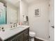 Bathroom with a vanity, framed mirror, toilet, and decor at 7388 S Lafayette W Cir, Centennial, CO 80122