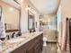 Bathroom featuring double vanity, granite countertop, tiled shower, and modern fixtures at 7388 S Lafayette W Cir, Centennial, CO 80122