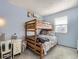 Cozy bedroom featuring a wooden bunk bed and a shelf for added storage at 7388 S Lafayette W Cir, Centennial, CO 80122