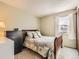 A tidy bedroom with bed, dresser, and window at 7388 S Lafayette W Cir, Centennial, CO 80122