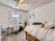 Bright bedroom with white walls, desk, bed, and natural light from the window at 7388 S Lafayette W Cir, Centennial, CO 80122