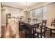 Dining area with hardwood floors leads into a bright kitchen, perfect for entertaining and Gathering meals at 7388 S Lafayette W Cir, Centennial, CO 80122