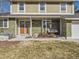 Inviting front porch with a charming swing and double door entry, perfect for relaxing and enjoying the outdoors at 7388 S Lafayette W Cir, Centennial, CO 80122