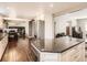 Kitchen and dining area with stainless steel appliances, hardwood floors, and modern cabinetry at 7388 S Lafayette W Cir, Centennial, CO 80122