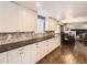 White cabinets and dark countertops in a kitchen at 7388 S Lafayette W Cir, Centennial, CO 80122