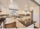 A kitchen island with granite countertop enhances this renovated kitchen at 7388 S Lafayette W Cir, Centennial, CO 80122