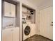 Functional laundry room with washer, dryer, sink, and storage cabinets at 7388 S Lafayette W Cir, Centennial, CO 80122