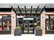 Modern building entrance with glass canopy and brick facade at 273 S Jackson St, Denver, CO 80209