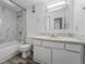 Well-lit bathroom with a vanity and a stylish shower-tub combination at 5995 W Hampden Ave # 3I, Denver, CO 80227