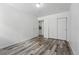 Bright bedroom showcasing wood-look flooring and double closets for convenient storage solutions at 5995 W Hampden Ave # 3I, Denver, CO 80227