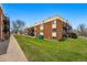 Exterior of brick apartment complex with green grass and black metal balconies at 5995 W Hampden Ave # 3I, Denver, CO 80227