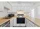 Well-maintained kitchen featuring neutral countertop, white cabinets and stainless steel sink at 5995 W Hampden Ave # 3I, Denver, CO 80227