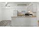 Clean kitchen with white appliances, countertop space, and overhead lighting at 5995 W Hampden Ave # 3I, Denver, CO 80227