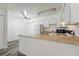 Clean kitchen with white appliances, countertop space, and overhead lighting at 5995 W Hampden Ave # 3I, Denver, CO 80227
