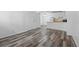 Open-concept living and kitchen area featuring modern luxury vinyl flooring at 5995 W Hampden Ave # 3I, Denver, CO 80227