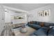 Open concept living room and kitchen, with luxury vinyl floors, stylish decor and updated appliances at 5995 W Hampden Ave # 3I, Denver, CO 80227
