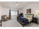 Bedroom with vaulted ceilings features a ceiling fan and a large window with neutral drapes at 9604 Brentwood Way # B, Broomfield, CO 80021