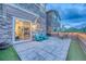 Cozy back patio features outdoor seating, artificial turf, and stone exterior home at 24806 E Calhoun Pl # A, Aurora, CO 80016