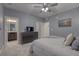 Neutral bedroom features an ensuite bathroom, a television, and soft grey carpet at 24806 E Calhoun Pl # A, Aurora, CO 80016