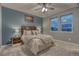 Comfortable bedroom featuring a plush bed, ambient lighting, and large windows at 24806 E Calhoun Pl # A, Aurora, CO 80016