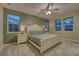 Spacious bedroom with three windows, ceiling fan, and plush carpet at 24806 E Calhoun Pl # A, Aurora, CO 80016