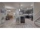 This open kitchen has grey cabinets, stainless appliances, a spacious island with seating, hardwood floors, and an eat-in area at 24806 E Calhoun Pl # A, Aurora, CO 80016
