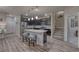 Modern kitchen boasts a large island with seating and sleek, stainless steel appliances at 24806 E Calhoun Pl # A, Aurora, CO 80016