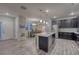 Well-lit kitchen featuring dark cabinets, stainless steel appliances, and island with seating at 24806 E Calhoun Pl # A, Aurora, CO 80016