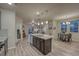 Modern kitchen featuring a large island with seating and an open floor plan at 24806 E Calhoun Pl # A, Aurora, CO 80016
