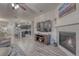 Open-concept living room with fireplace and view of the modern kitchen at 24806 E Calhoun Pl # A, Aurora, CO 80016