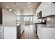 Modern kitchen with granite countertops, stainless steel appliances, and an island at 6860 Merseyside Ln, Castle Pines, CO 80108