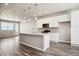 Modern kitchen with white cabinets, granite countertops, and an island at 6860 Merseyside Ln, Castle Pines, CO 80108