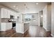 Modern kitchen with white cabinets, granite countertops, and an island at 6860 Merseyside Ln, Castle Pines, CO 80108