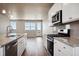 Modern kitchen with granite countertops and stainless steel appliances at 6860 Merseyside Ln, Castle Pines, CO 80108