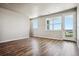 Bright living room with hardwood floors and access to a balcony at 6860 Merseyside Ln, Castle Pines, CO 80108