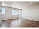 Bright living room with hardwood floors and access to a balcony at 6860 Merseyside Ln, Castle Pines, CO 80108