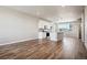 Open living room with hardwood floors and kitchen views at 6860 Merseyside Ln, Castle Pines, CO 80108