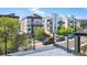 View from balcony of contemporary homes on a tree-lined street on a sunny day at 1238 N Tennyson St, Denver, CO 80204