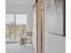 Light and airy bedroom with balcony access and a sliding barn door to the bathroom at 1238 N Tennyson St, Denver, CO 80204